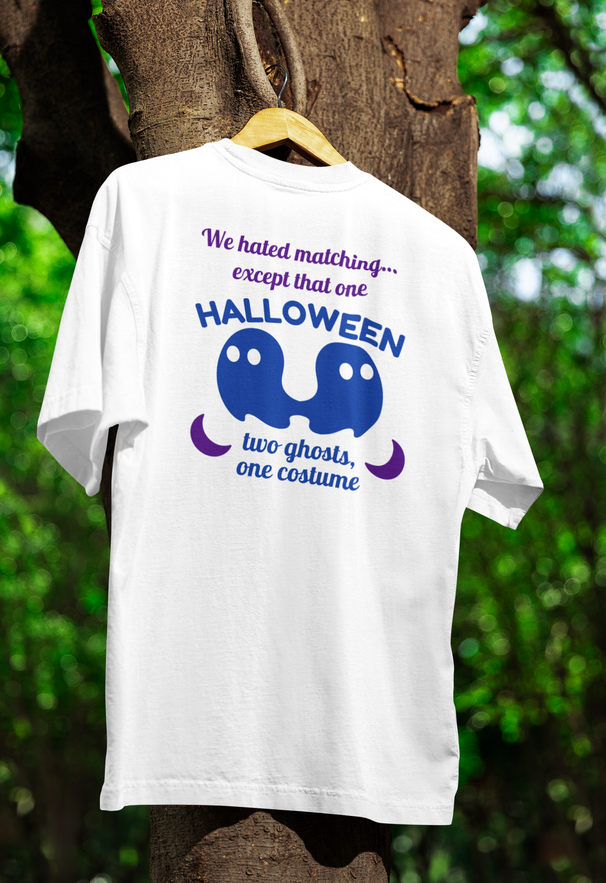 a white funny twin t-shirt hanging on a tree 