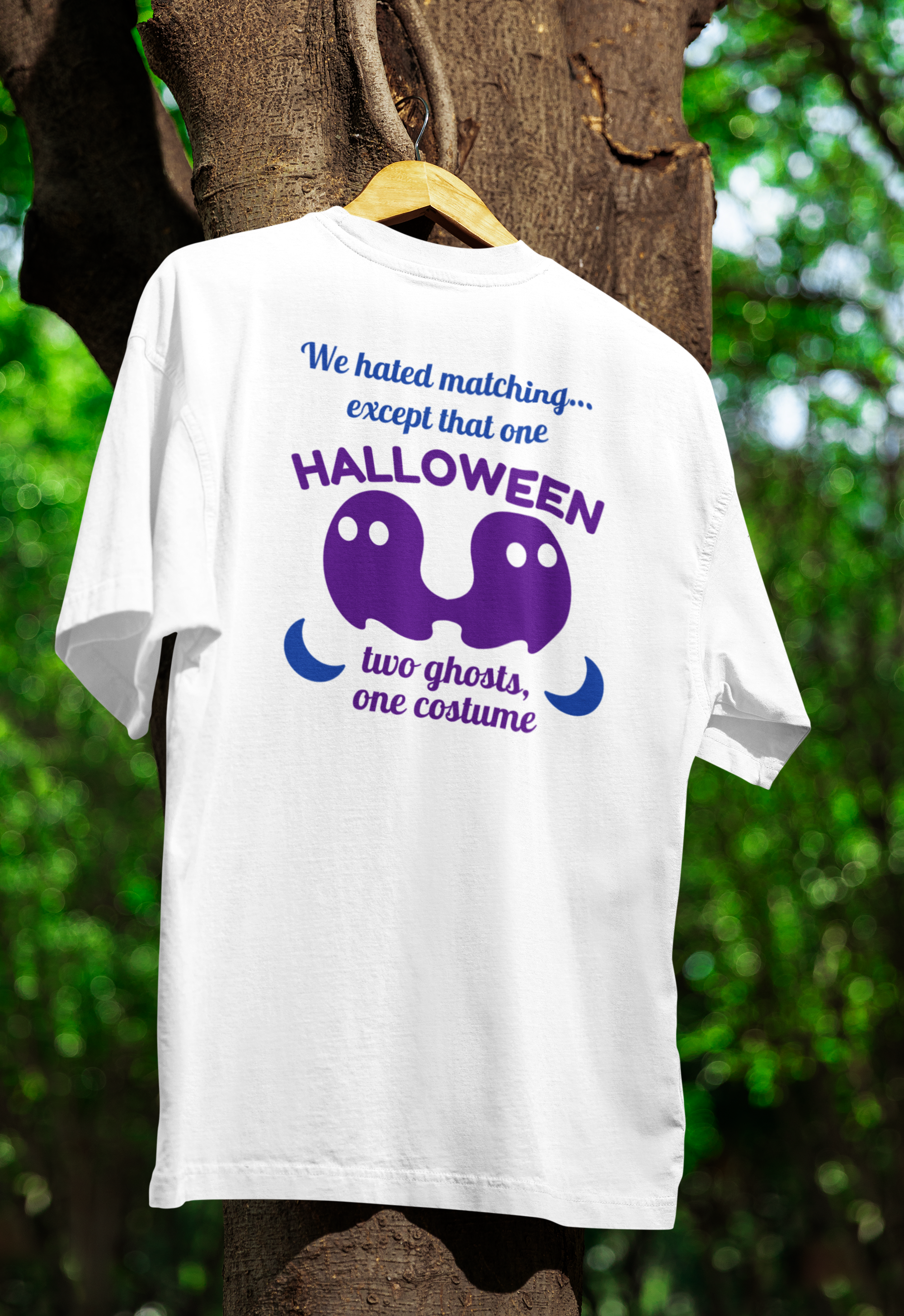 a white funny twin t-shirt hanging on a tree