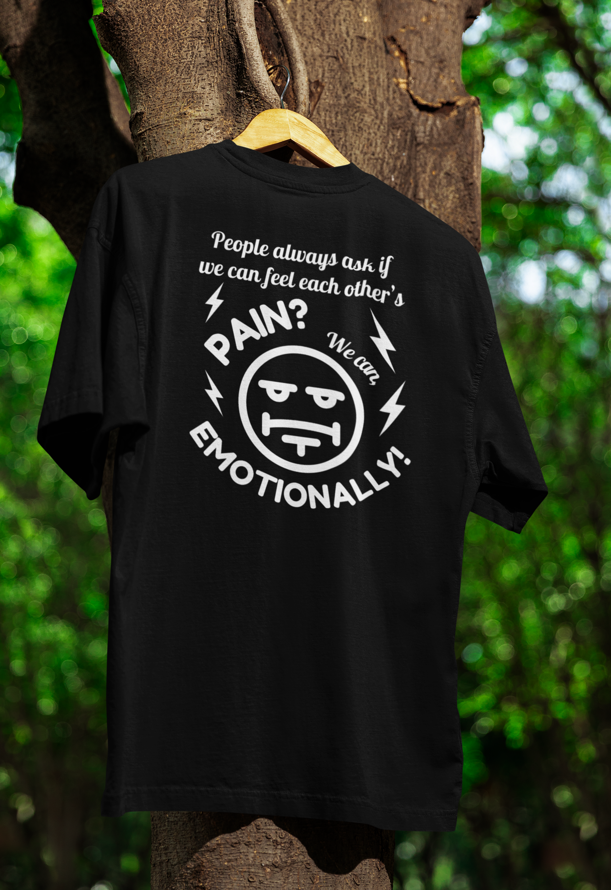 a black funny twin t-shirt hanged on a tree