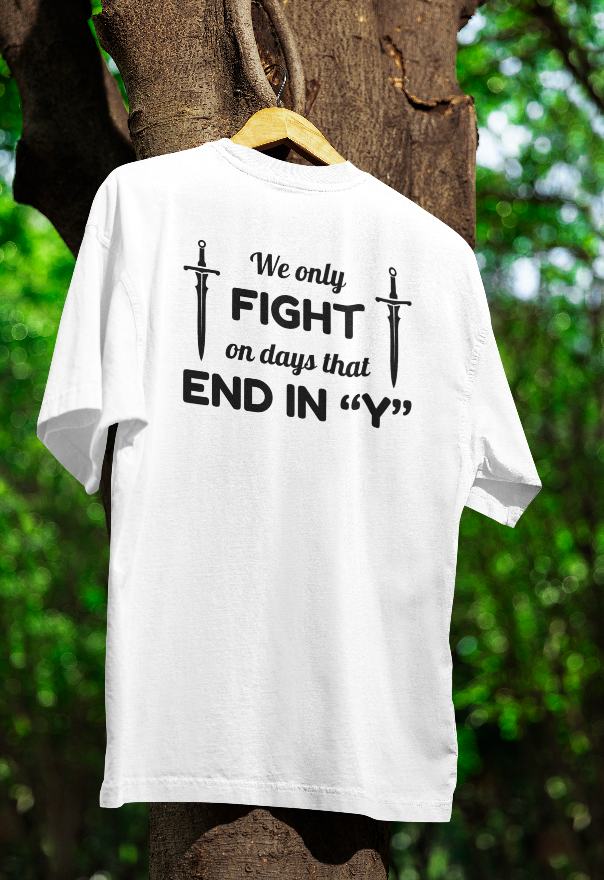 a white funny twin t-shirt hanged on a tree