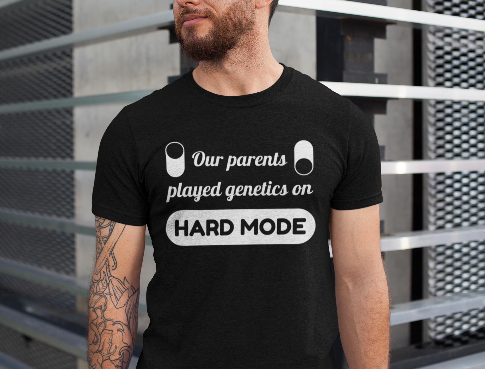 Person wearing a black t-shirt for twins with humorous text design against a metallic background