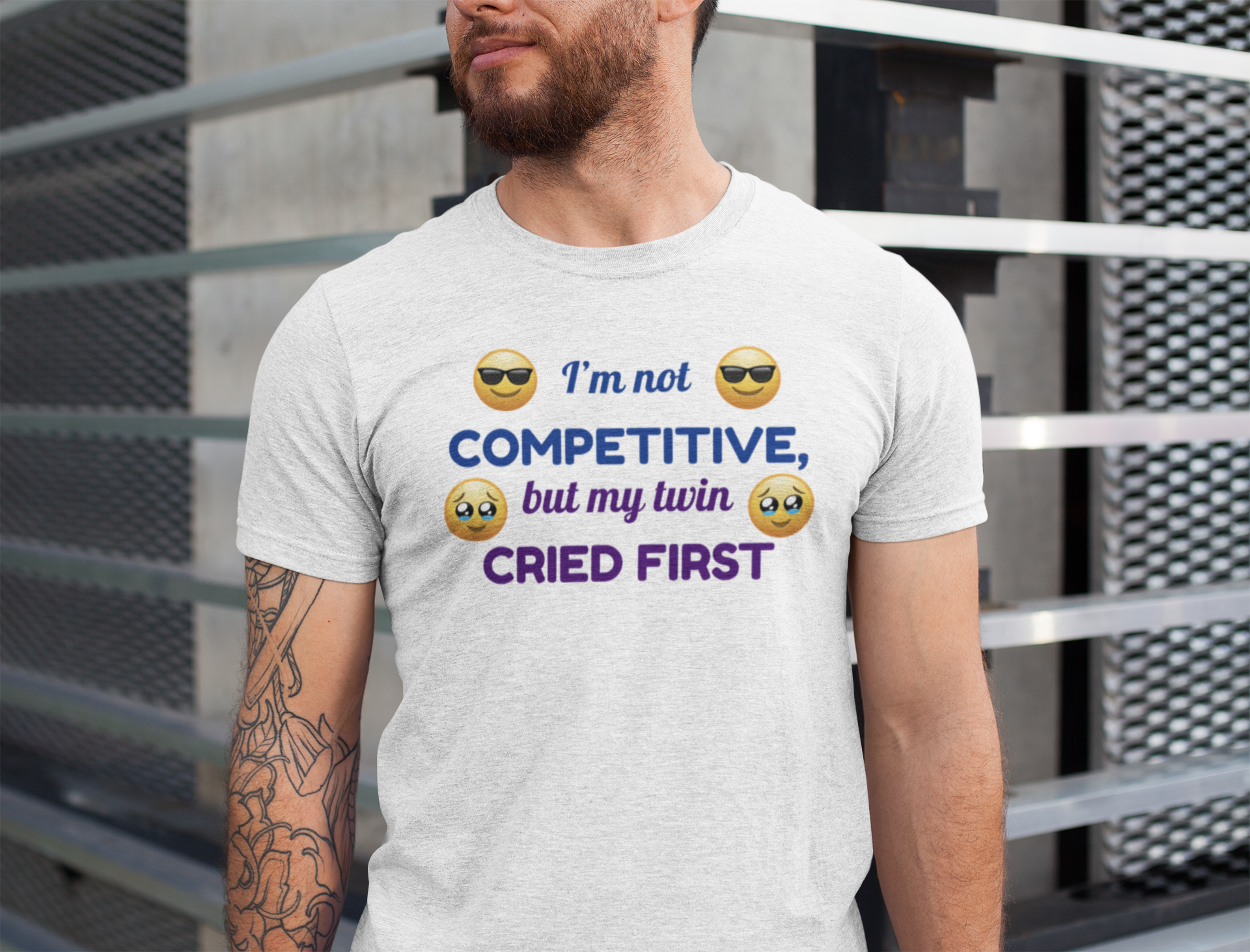 Man wearing a t-shirt for twins with a humorous message and emojis.