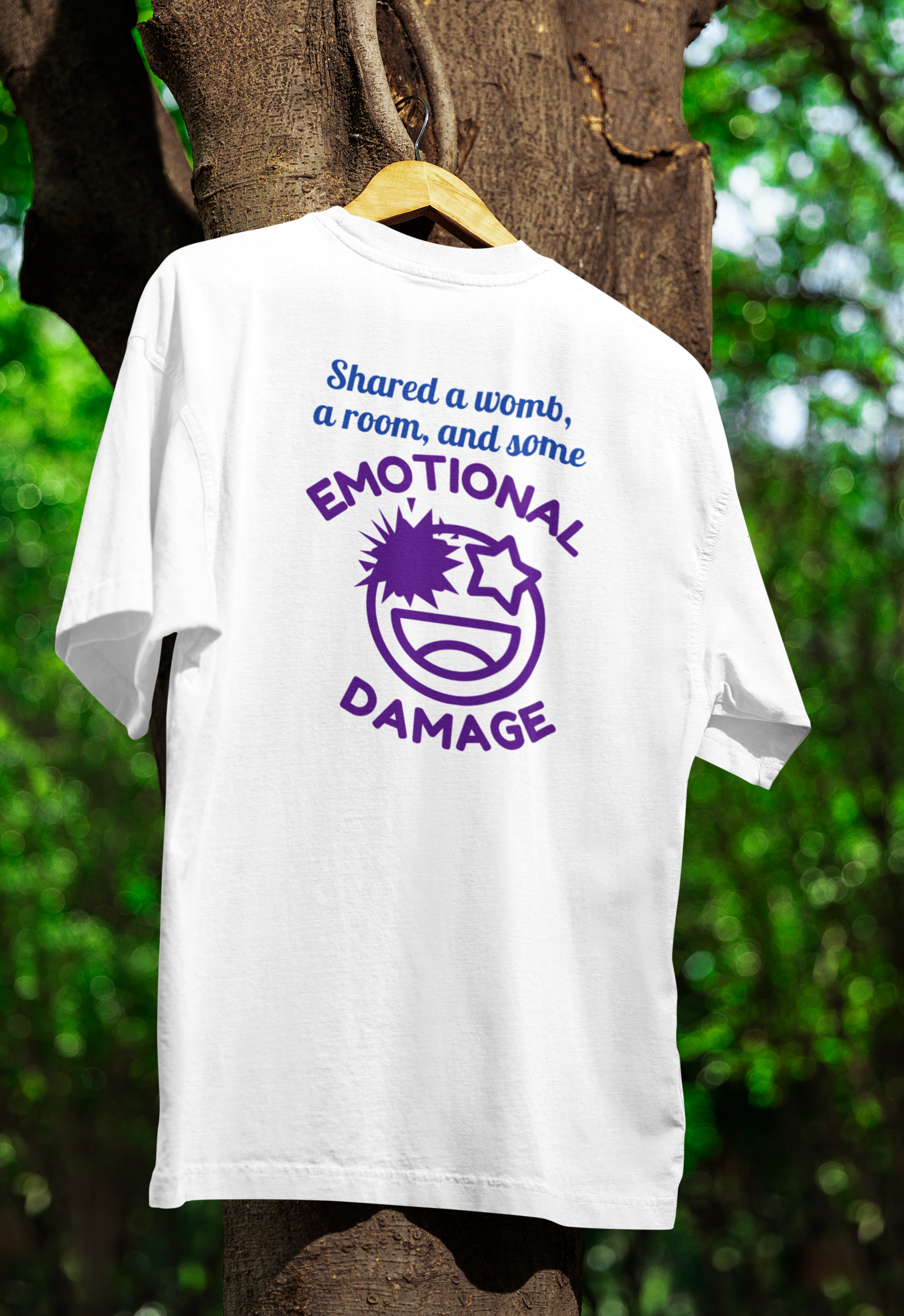 a white funny twin t-shirt hanged on a tree