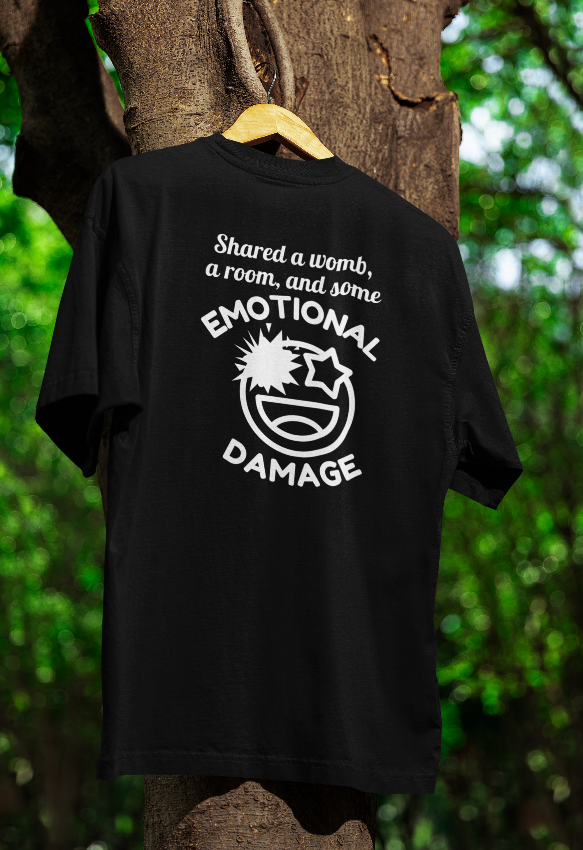 a black funny twin t-shirt hanged on a tree 
