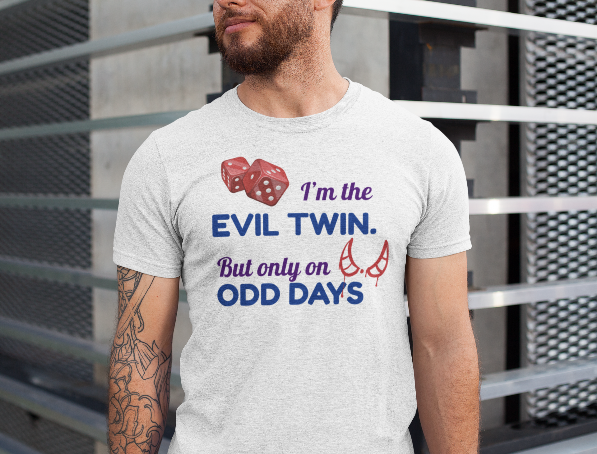 Man wearing a t-shirt for twins with a humorous text design in front of a metal fence.