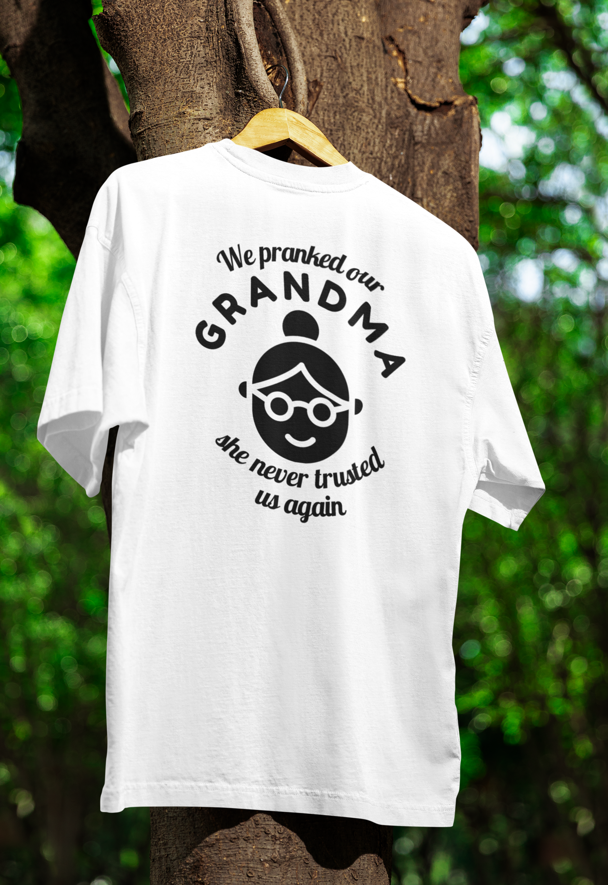 A white funny twin t-shirt hanged on tree