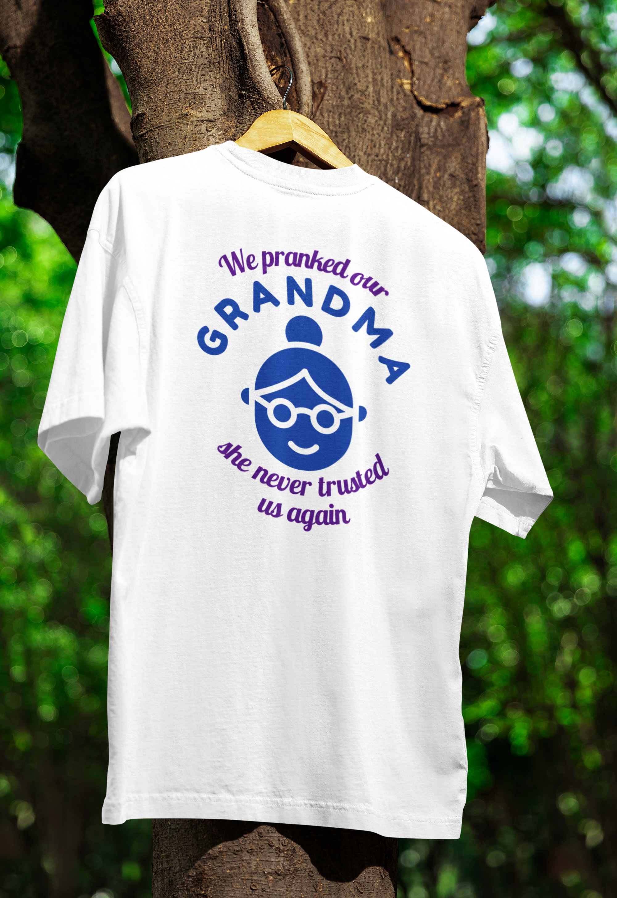 A white funny twin t-shirt hanged on tree