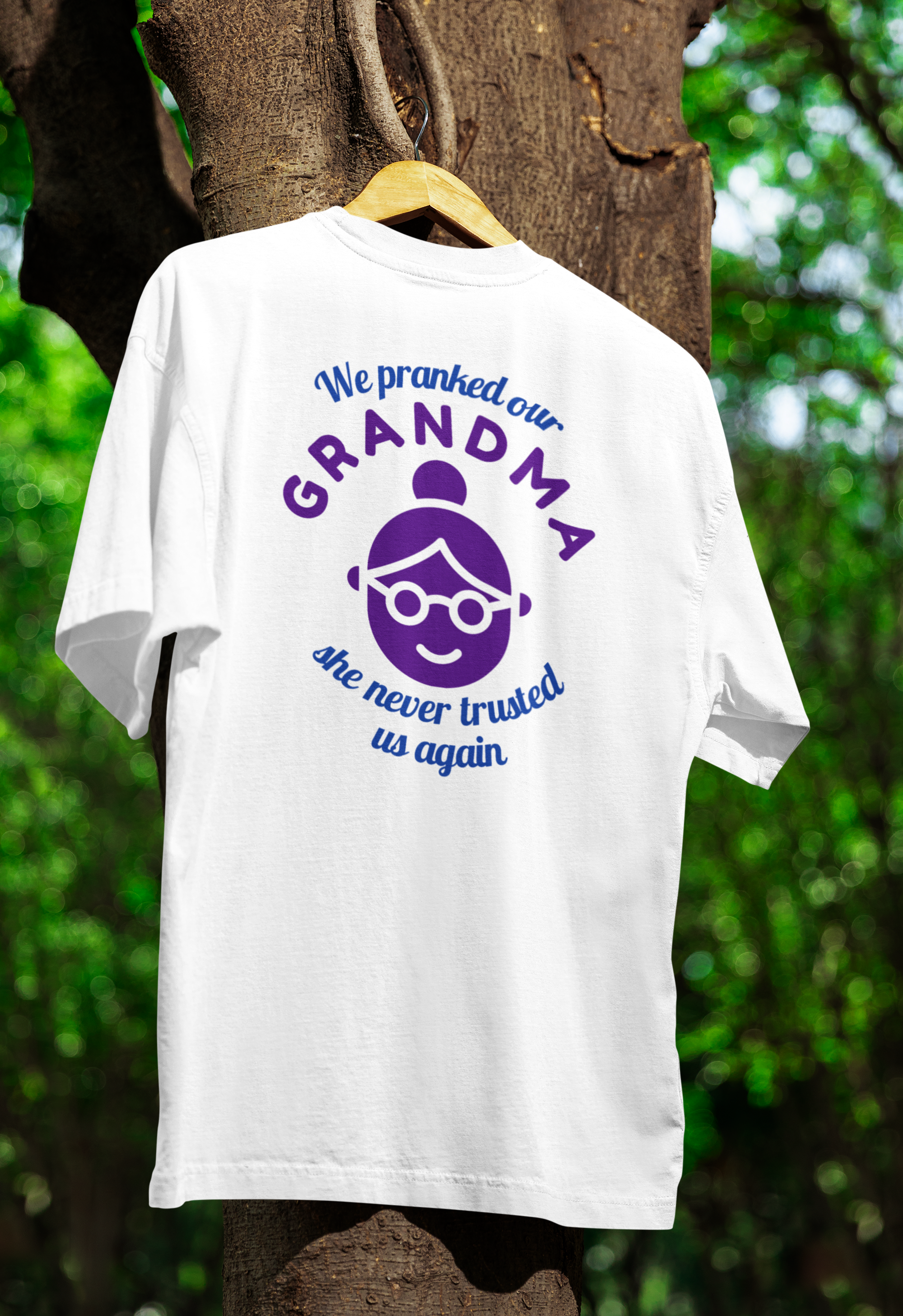 A white funny twin t-shirt hanged on tree