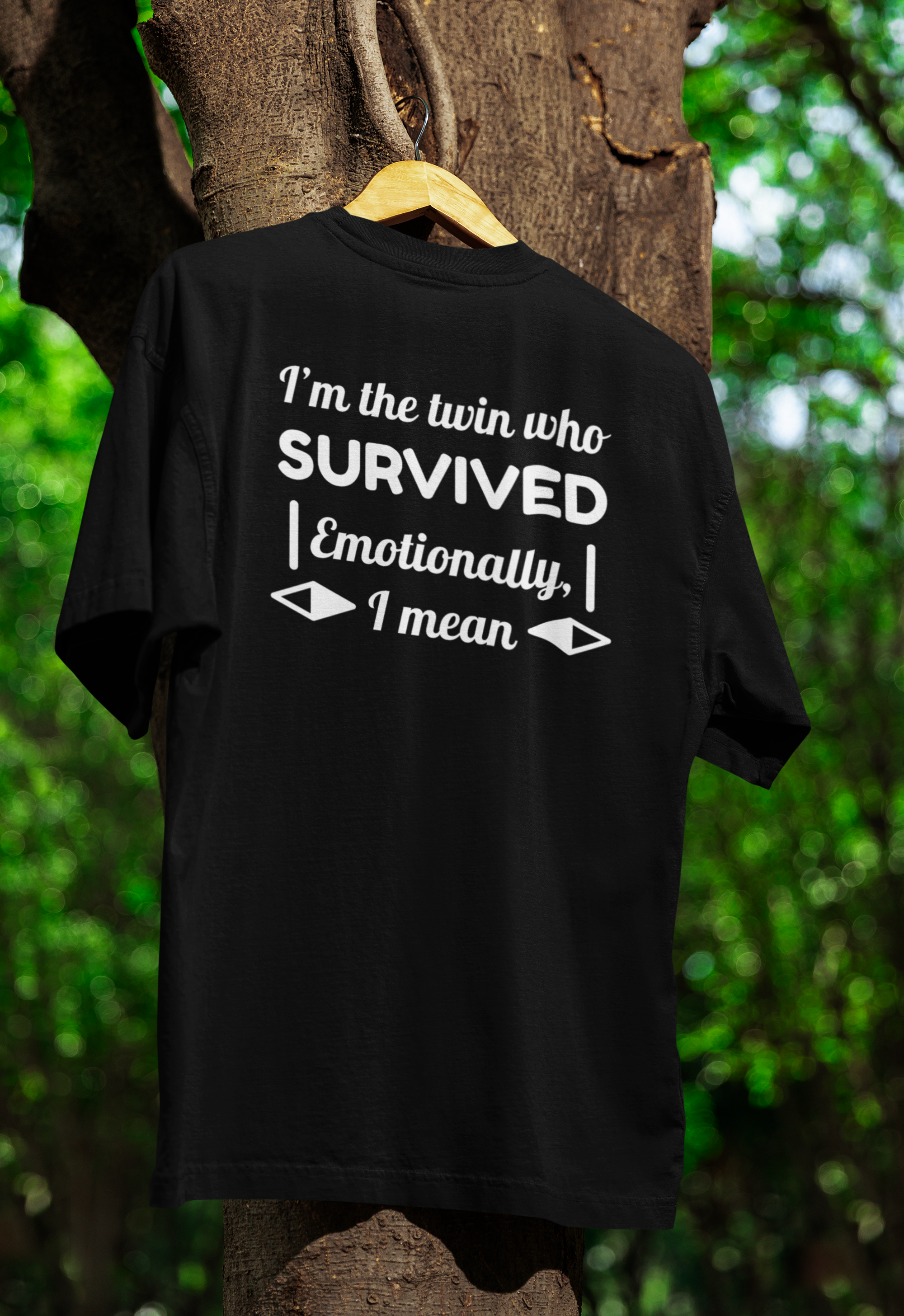 Black t-shirt for twins with humorous text design hanging on a tree