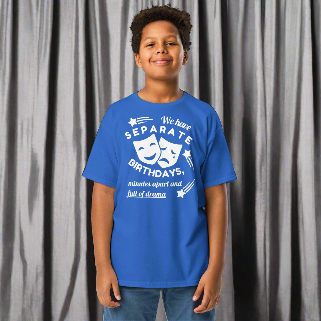 A boy wearing blue Twin t-shirt with white text about Twin Birthdays. 