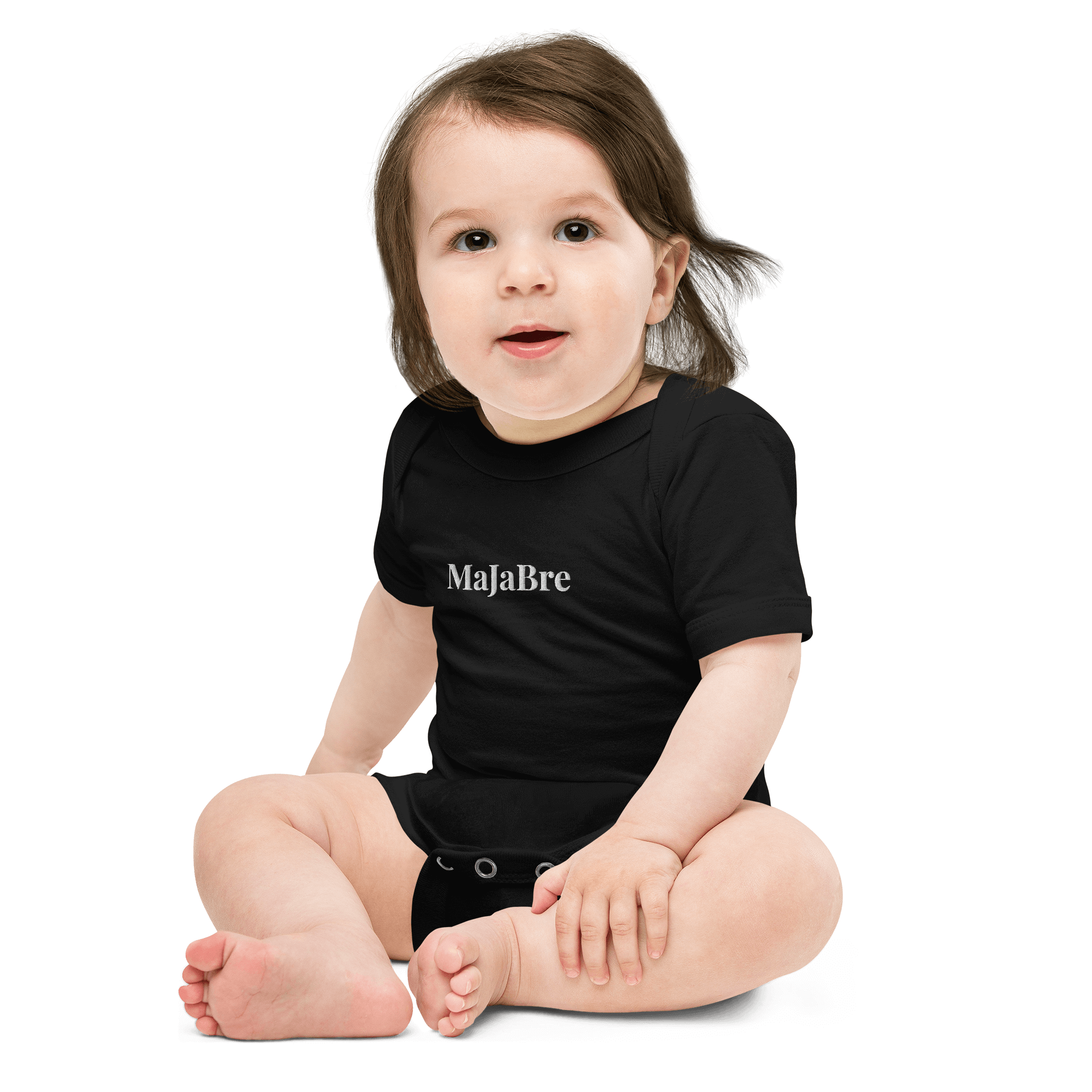 A baby wearing black twin bodysuit with white majabre sign